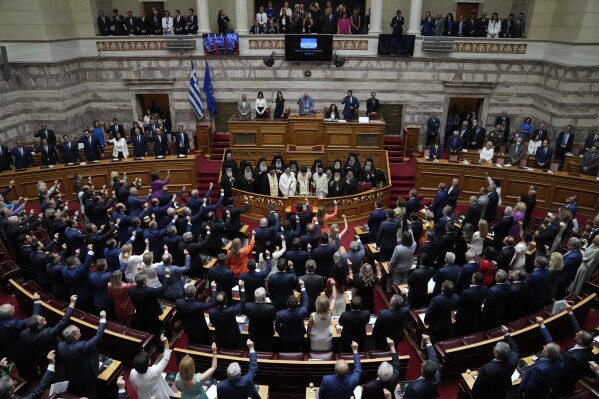 Greek lawmakers take the oath during a swearing in ceremony at the parliament in Athens, Greece, Monday, July 3, 2023. The new government's policy statement will be subject to a three-day debate, beginning on Thursday. The debate will culminate in a vote on Saturday, during which the new government will seek a vote of confidence from the parliament. (AP Photo/Thanassis Stavrakis)