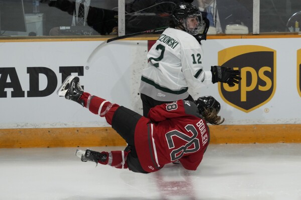 Boston's Taylor Wenczkowski collides with Ottawa's Amanda Boulier at center ice during the third period of a PWHL hockey game, Wednesday, Jan. 24, 2024 in Ottawa, Ontario. (Adrian Wyld/The Canadian Press via AP)