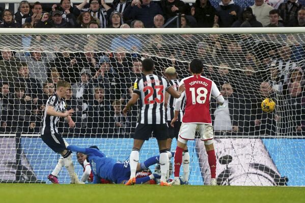 Newcastle United's Anthony Gordon scores his side's first goal , during the English Premier League soccer match between Newcastle United and Arsenal at St. James' Park, in Newcastle upon Tyne, England, Saturday, Nov. 4, 2023. (Owen Humphreys/PA via AP)