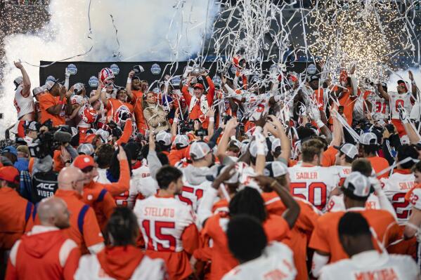 Clemson coach Dabo Swinney holds up the trophy after Clemson defeated North Carolina in the Atlantic Coast Conference championship NCAA college football game Saturday, Dec. 3, 2022, in Charlotte, N.C. (AP Photo/Jacob Kupferman)