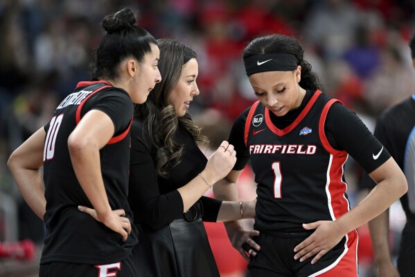 FILE - Fairfield coach Carly Thibault-DuDonis speaks with Kendall McGruder (1) and Izabela Nicoletti Leite (10) during an NCAA college basketball game against Marist, Thursday, Feb. 8, 2024, in Fairfield, Conn. Thibault-DuDonis is in her second year as a head coach, leading Fairfield to a 22-1 record and a 20-game winning streak. (Cloe Poisson/Hartford Courant via AP, File)
