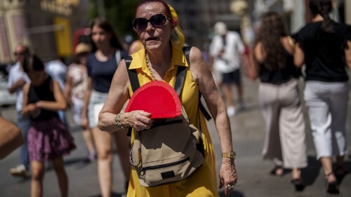 FILE - A woman fans herself in Madrid, Spain, July 10, 2023. A new study Tuesday, July 25, finds these intense and deadly hot spells gripping much of the globe in the American Southwest and Southern Europe could not have occurred without climate change. (AP Photo/Manu Fernandez, File)