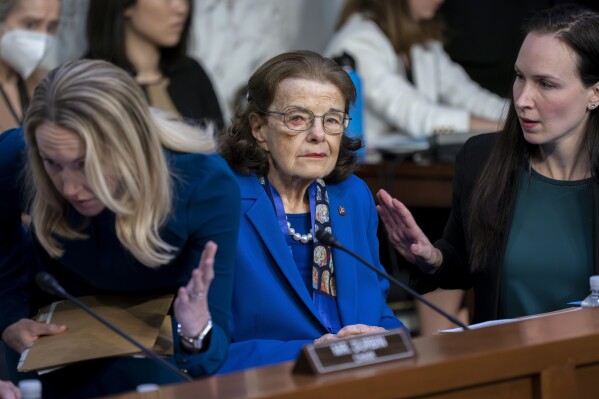 FILE - U.S. Sen. Dianne Feinstein, D-Calif., is flanked by aides as she returns to the Senate Judiciary Committee following a more than two-month absence as she was being treated for a case of shingles, at the Capitol in Washington, Thursday, May 11, 2023. (AP Photo/J. Scott Applewhite, File)