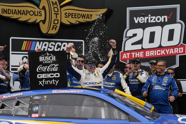 FILE - Michael McDowell celebrates after winning the NASCAR Cup Series auto race at Indianapolis Motor Speedway in Indianapolis, Sunday, Aug. 13, 2023. McDowell will not return to Front Row Motorsports after this season, he announced Wednesday morning, May 8, 2024. (AP Photo/Michael Conroy, File)