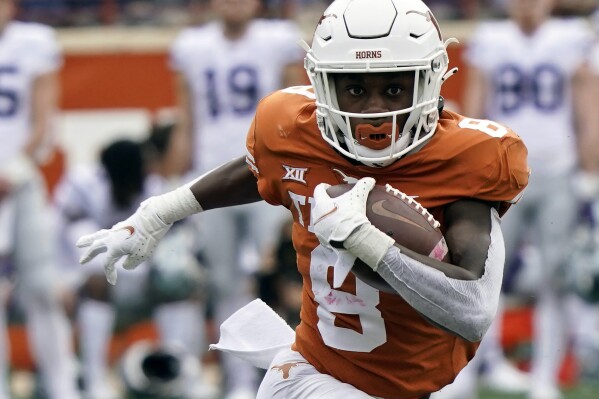 FILE - Texas' Xavier Worthy runs with ball against Kansas State during the first half of an NCAA college football game in Austin, Texas, Nov. 26, 2021. With receiver Worthy among 10 starters back on offense, linebacker Jaylan Ford still leading on defense after not turning pro, and key transfers adding depth on both sides, Texas is considered by most as the overwhelming preseason Big 12 favorite in coach Steve Sarkisian’s third season. (AP Photo/Chuck Burton, File)