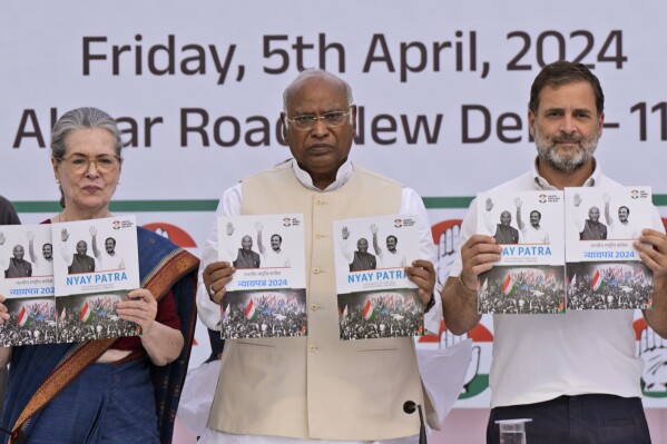FILE- India’s opposition Congress party leaders from left, Sonia Gandhi, Mallikarjun Kharge, and Rahul Gandhi, display copies of party’s election manifesto during a press conference in New Delhi, India, April 5, 2024. India's 6-week-long general election starts on April 19 and results will be announced on June 4. (AP Photo/Manish Swarup, File)