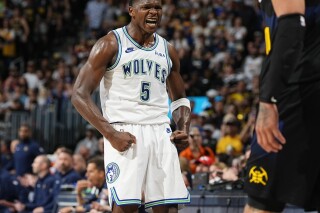 Minnesota Timberwolves guard Anthony Edwards reacts after hitting a basket over Denver Nuggets forward Aaron Gordon in the second half of Game 7 of an NBA second-round playoff series, Sunday, May 19, 2024, in Denver. (AP Photo/David Zalubowski)