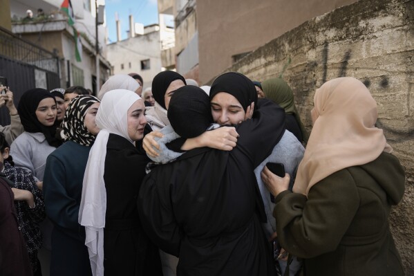 Dunya Shtayyeh, center, was released from an Israeli prison as part of a ceasefire deal between Israel and Hamas, in the West Bank village of Salem, Jan. 20, 2025. (AP Photo/Majdi Mohammed, File)