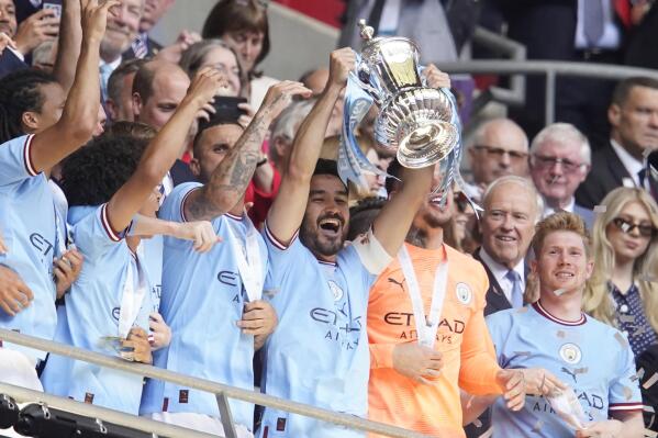 Manchester City's Erling Haaland holds the winners trophy as he celebrates  winning the English FA Cup final soccer match between Manchester City and  Manchester United at Wembley Stadium in London, Saturday, June