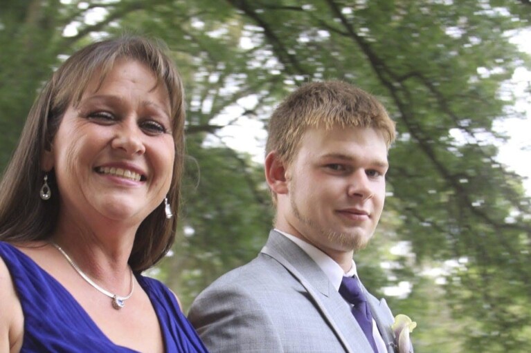 This 2012 family photo shows Austin Hunter Turner with his mother, Karen Goodwin, at the wedding of her oldest son. Turner died in 2017, at the age of 23, after an encounter with the Bristol Police Department. His family has raised questions about the Tennessee Bureau of Investigation’s review of Hunter's death and the local prosecutor’s decision not to charge police. (Kim Rutledge via AP)