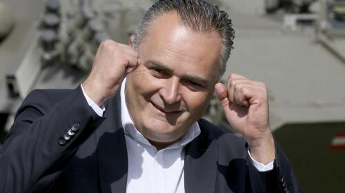 FILE - Then Austrian defense minister Hans Peter Doskozil reacts during a joint military exercise in Allensteig, Austria, Friday, Sept. 15, 2017. Austria’s main center-left opposition party has reversed the result of its weekend leadership election, announcing that a computer error originally led to the wrong candidate being declared the winner. At a hastily called news conference on Monday, the head of the party's electoral commission announced that it was in fact Andreas Babler and not Hans Peter Doskozil who won, taking 317 votes to Doskozil's 280, the Austria Press Agency reported. (AP Photo/Ronald Zak, File)