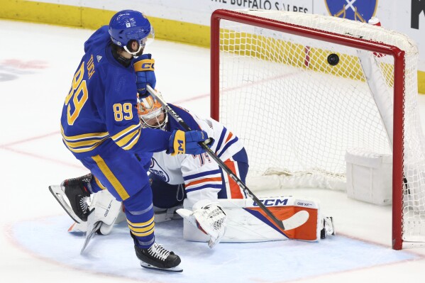 Buffalo Sabres right wing Alex Tuch (89) puts the puck past Edmonton Oilers goaltender Stuart Skinner (74) during the shootout of an NHL hockey game Saturday, March 9, 2024, in Buffalo, N.Y. (AP Photo/Jeffrey T. Barnes)