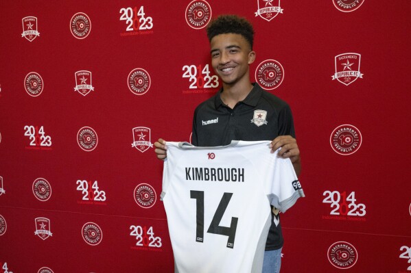 Da'vian Kimbrough, 13, holds up his jersey after signing contract with the Sacramento Republic of the second-tier League Championship of the United Soccer League, Tuesday, Aug. 8, 2023, in Sacramento, Calif. (Paul Kitagaki Jr./The Sacramento Bee via AP)