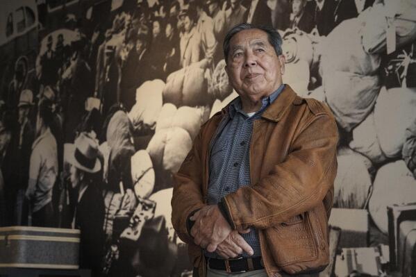 Ron Wakabayashi pauses for a picture at the Japanese American National Museum in Los Angeles on Saturday, Feb. 11, 2023. “Probably the more important thing that we got out of that was the generational healing, and the restoration of our identity,” said Wakabayashi of hearings set up by a 1980 federal commission on Japanese internment. (AP Photo/Damian Dovarganes)
