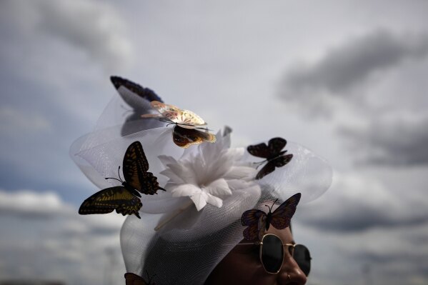 A race fan watches from the stands at Churchill Downs before the 151st running of the Kentucky Oaks horse race Friday, May 2, 2025, in Louisville, Ky. (AP Photo/Brynn Anderson)