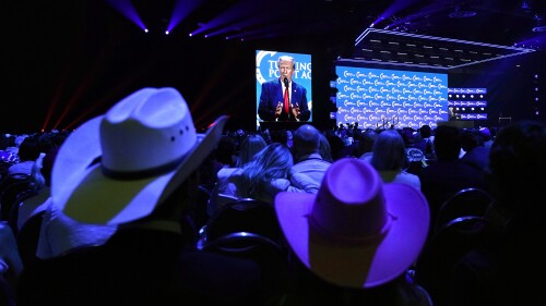 People listen as former President Donald Trump speaks at the Turning Point Action conference, Saturday, July 15, 2023, in West Palm Beach, Fla. (AP Photo/Lynne Sladky)