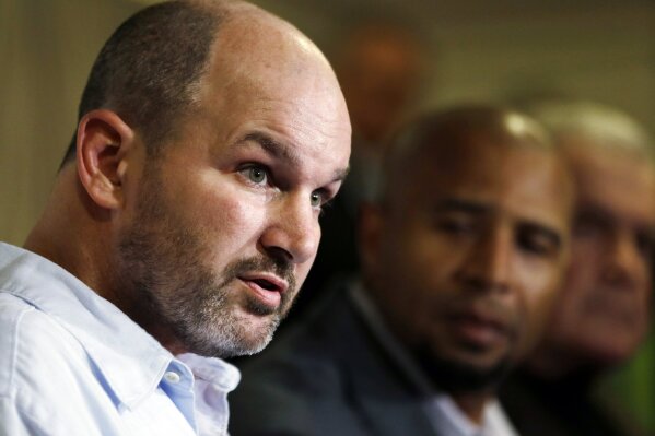 
              FILE - In this April 9, 2013, file photo, former NFL player Kevin Turner, left, speaks during a news conference in Philadelphia, as former players Dorsey Levens, center, and Bill Bergey listen. A fullback at Alabama before playing eight years in the NFL for New England and Philadelphia, Kevin Turner was 46 when he died in 2016. He had been diagnosed with amyotrophic lateral sclerosis, known as ALS or Lou Gehrig's disease, but after studying his brain researchers declared that it was actually CTE.  (AP Photo/Matt Rourke, File)
            