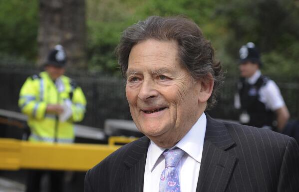 In this May 7, 2013 file photo, former Chancellor of the Exchequer Nigel Lawson arrives at a television studio in Westminster. Lawson, the tax-cutting UK Treasury chief under the late Margaret Thatcher and a lion of Conservative politics in the late 20th century has died. He was 91. (Stefan Rousseau/PA via AP)