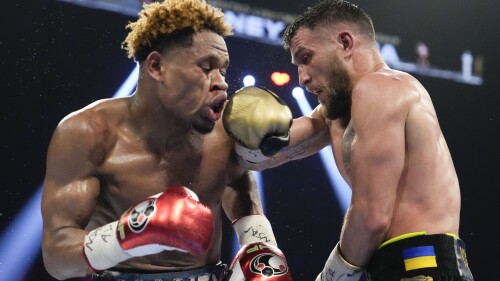 FILE - Devin Haney, left, fights Vasiliy Lomachenko in an undisputed lightweight championship boxing match, May 20, 2023, in Las Vegas. Haney won by unanimous decision. Haney was arrested on a felony weapons charge, Thursday, July 13, in Los Angeles, according to police. (AP Photo/John Locher, File)