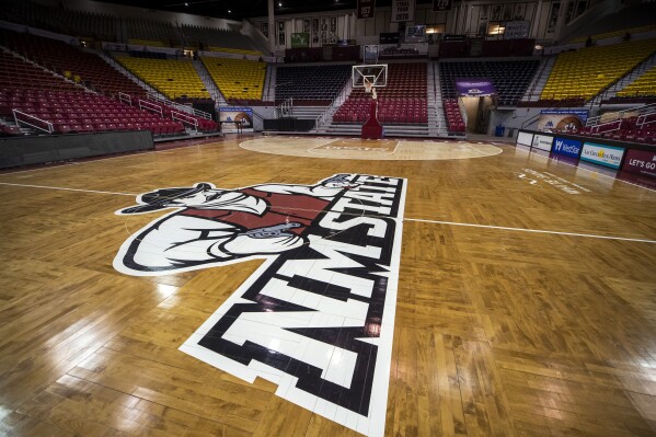 FILE - The basketball court of the Pan American Center at New Mexico State University is seen Feb. 15, 2023, in Las Cruces, N.M. Two former New Mexico State basketball players and a team manager filed a lawsuit Monday, Nov. 6, 2023 saying their teammates frequently brought guns into the locker room where they assaulted players under the guise of the attacks serving as a team-building exercise. (AP Photo/Andrés Leighton, File)