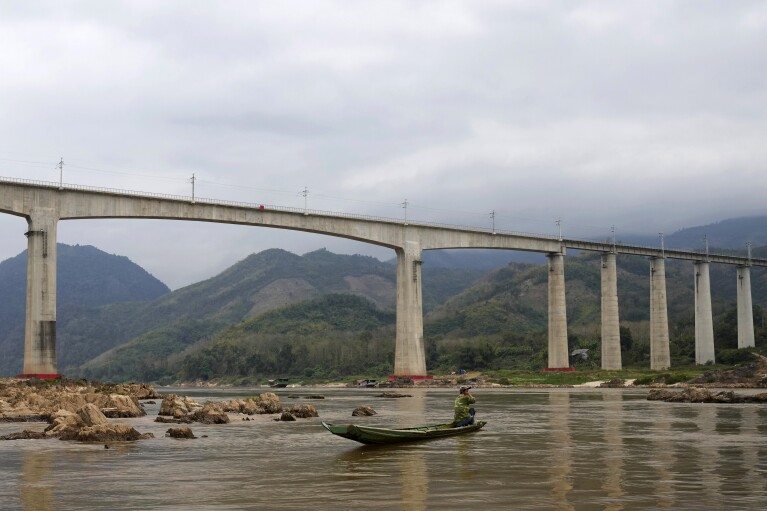 The overpass for the high speed raill system is seen in Mekong river in Luang Prabang, Laos, Sunday, Jan. 28, 2024. (AP Photo/Sakchai Lalit)