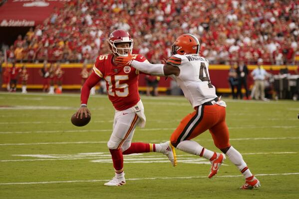 Kansas City Chiefs quarterback Patrick Mahomes (15) scrabbles away from Cleveland Browns linebacker Anthony Walker Jr. (4) during the second half of an NFL football game Sunday, Sept. 12, 2021, in Kansas City, Mo. (AP Photo/Charlie Riedel)