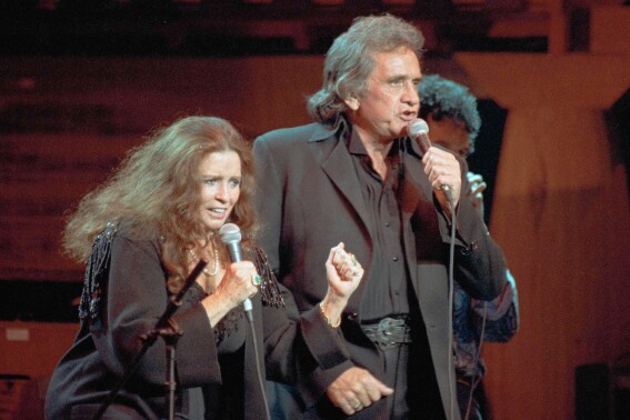In this Oct. 16, 1992, file photo, singers June Carter Cash and husband Johnny Cash perform at New York's Madison Square Garden. (AP Photo/Ron Frehm, File)