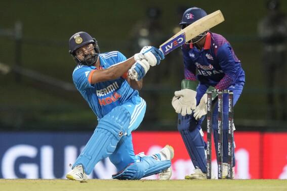 India's Rohit Sharma plays a shot as Nepal's wicketkeeper Aasif Sheikh watches during the Asia Cup cricket match between India and Nepal in Pallekele, Sri Lanka on Monday, Sep. 4. (AP Photo/Eranga Jayawardena)
