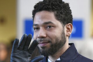 FILE - In this March 26, 2019 file photo, actor Jussie Smollett smiles and waves to supporters before leaving Cook County Court after his charges were dropped in Chicago. A decision is expected on a motion in federal court Tuesday, Oct. 22 by Smollertt's lawyer asking that the city of Chicago's lawsuit against him requesting costs of investigation be dismissed.(AP Photo/Paul Beaty, File)