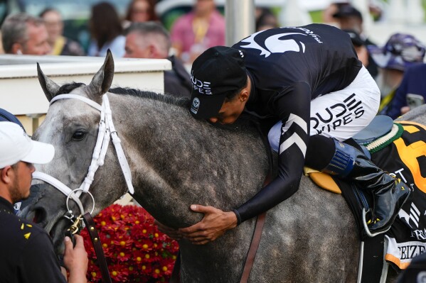 Jaime Torres kisses Seize The Grey after they won the Preakness Stakes horse race at Pimlico Race Course, Saturday, May 18, 2024, in Baltimore. (AP Photo/Julia Nikhinson)