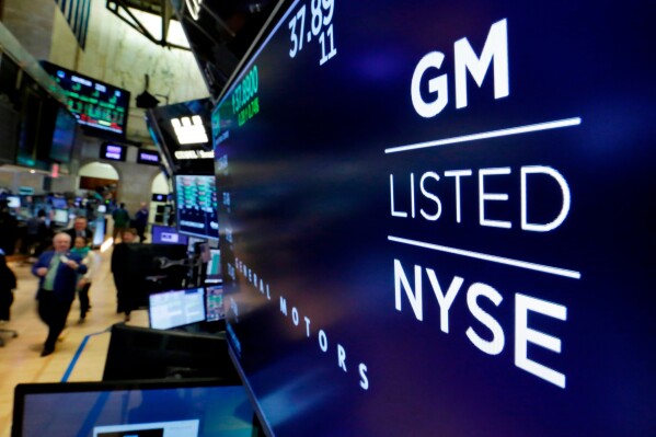 FILE- In this April 23, 2018, file photo, the logo for General Motors appears above a trading post on the floor of the New York Stock Exchange. General Motors Co. reports earnings on Tuesday July 25, 2023. (AP Photo/Richard Drew, File)