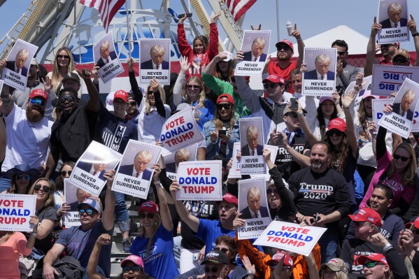 People cheer for a photo ahead of a campaign rally for Republican presidential candidate former President Donald Trump in Wildwood, N.J., Saturday, May 11, 2024. (AP Photo/Matt Rourke)