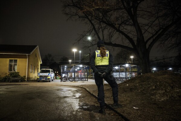 Police on site at Södra station in central Örebro Sweden, where three people dead after an accident with a train on Wednesday evening, Feb. 28, 2024. The three people have died when hit by a freight train at a railway crossing. The victims — a man aged 25, a woman in her 20s and a third person who was not immediately identified — had just gotten off a train, crossed the tracks and didn’t see the freight train. (Pavel Koubek/TT News Agency via AP)