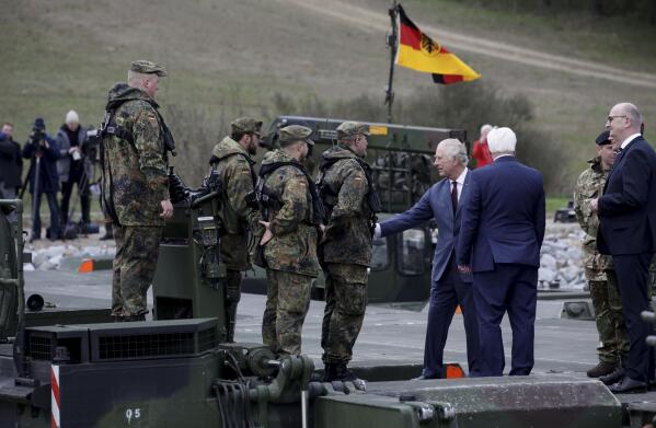 Britain's King Charles III, third right, talks with soldiers during his visit at the 130th German-British Pioneer Bridge Battalion military unit in Finowfurt, eastern Germany, on Thursday, March 30, 2023.(Jens Schlueter /Pool Photo via AP)
