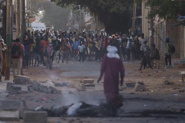 Demonstrators gather on a street during clashes with police at a neighborhood in Dakar, Senegal, Saturday, June 3, 2023. The clashes first broke out, later this week, after opposition leader Ousmane Sonko was convicted of corrupting youth and sentenced to two years in prison. (AP Photo/Leo Correa)