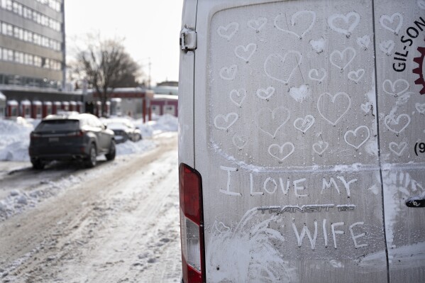 A message drawn in the dirt on a van is seen on Valentine's Day following a nor'easter winter storm that dropped several inches of snow in Halifax on Wednesday, Feb. 14, 2024. (Darren Calabrese/The Canadian Press via AP)
