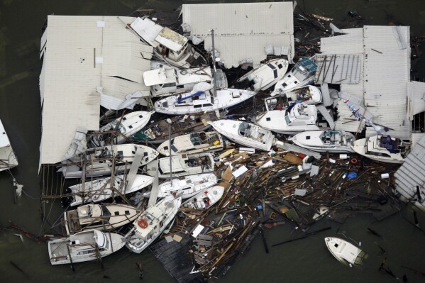 FILE - Boats and debris are piled up Sept. 13, 2008, in Galveston, Texas after Hurricane Ike hit the area. (AP Photo/David J. Phillip, Pool, File)