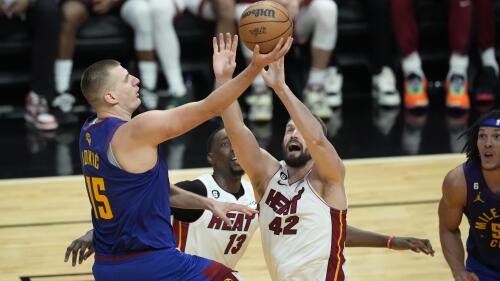 Denver Nuggets center Nikola Jokic (15) drives to the basket over Miami Heat forward Kevin Love (42) during the second half of Game 3 of the NBA Finals basketball game, Wednesday, June 7, 2023, in Miami. (AP Photo/Rebecca Blackwell)