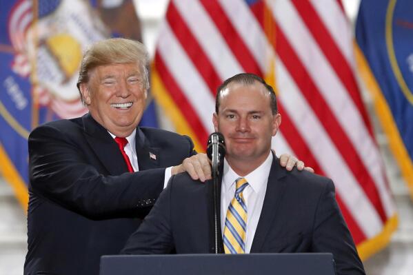 FILE - President Donald Trump stands with Sen. Mike Lee, R-Utah, on Dec. 4, 2017, at the Utah State Capitol, after Trump traveled to Salt Lake City to announce plans to shrink two sprawling national monuments in Utah. Lee has avoided serious challenge in deeply conservative Utah in the dozen years since he came to power in a Tea Party wave, but that's changing this year as he faces two GOP challengers and a newly empowered independent. (AP Photo/Rick Bowmer, File)
