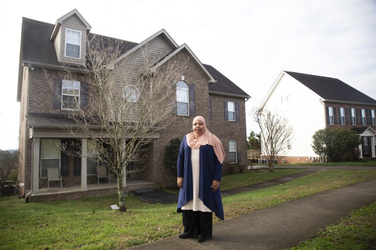 Imani Mfalme poses for a portrait outside her late mother's house Thursday, March 7, 2024, in Knoxville, Tenn. Mfalme's mother suffered from Alzheimer's and was placed in long term care. After her death the state is now trying to lay claim to the estate to pay for that care. (AP Photo/Caitie McMekin)