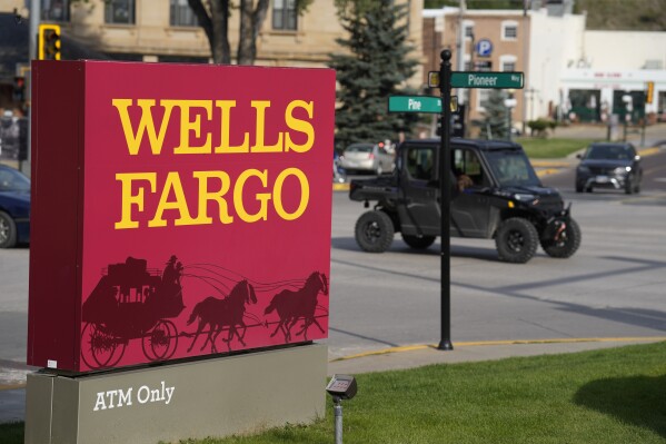 Traffic moves along Pioneer Way past the sign outside a branch of Wells Fargo bank Wednesday, Sept. 20, 2023, in Deadwood, S.D. Employees at a Wells Fargo location in New Mexico have voted to unionize, the first time that workers at a major U.S. bank have attempted to organize. (AP Photo/David Zalubowski)