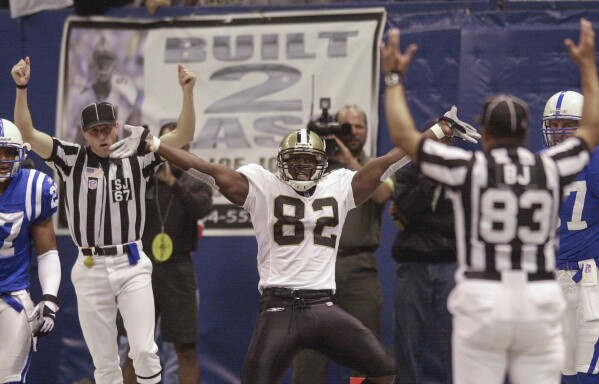 FILE - The New Orleans Saints' Boo Williams (82) celebrates following an eight-yard pass from Saints quarterback Aaron Brooks for a touchdown against the Indianapolis Colts at the Superdome in New Orleans Sunday, Nov. 18, 2001. Williams needs surgery, medicine and doctors to make the pain subside from injuries he endured during his football career. But he can't afford any of it. The 44-year-old was recently awarded $5,000 a month by the NFL's disability benefit plan. But Williams said the plan and the league have repeatedly mishandled his claims and should really have paid him $500,000 or more over the past 14 years. (AP Photo/James A. Finley, File)