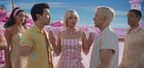 This image released by Warner Bros. Pictures shows, from left, Emma Mackey, Simu Liu, Margot Robbie, Ryan Gosling and Kingsley Ben-Adir in a scene from "Barbie." (Warner Bros. Pictures via AP)
