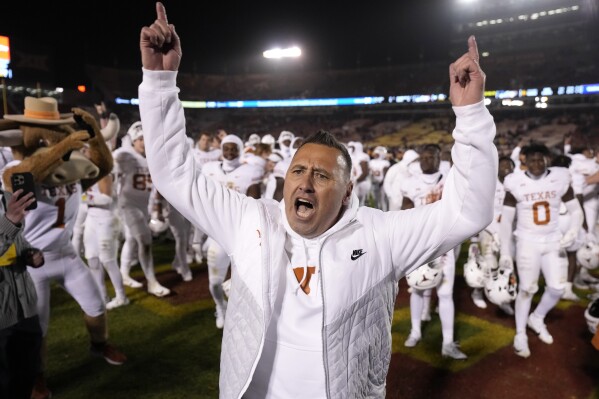 Texas head coach Steve Sarkisian celebrate after his team's win over Iowa State in an NCAA college football game Saturday, Nov. 18, 2023, in Ames, Iowa. (AP Photo/Matthew Putney)