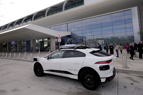 FILE 0 A Waymo self-driving vehicle sits curbside, Friday, Dec. 16, 2022, at the Sky Harbor International Airport Sky Train facility in Phoenix. Waymo is recalling more than 600 self-driving vehicles after one of them struck a telephone pole in Arizona. The National Highway Traffic Safety Administration said in its report that last month a driverless Waymo vehicle hit a wooden utility pole in Phoenix while it was in an alleyway and trying to perform a low-speed pullover maneuver. There were no passengers, other road users, or injuries associated with the event, the report said. (AP Photo/Matt York, File)