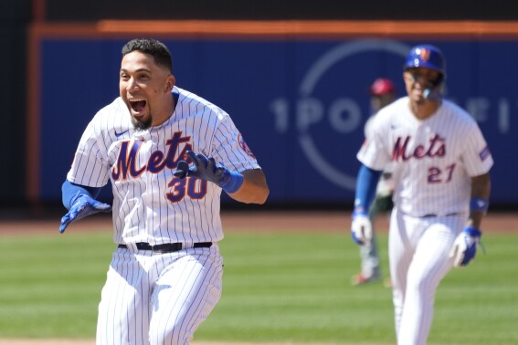 New York Mets' Rafael Ortega (30) reacts after hitting a walk off single during the ninth inning of a baseball game against the Los Angeles Angels, Sunday, Aug. 27, 2023, in New York. The Mets won 3-2. (AP Photo/Mary Altaffer)
