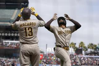 San Diego Padres' Fernando Tatis Jr., right, celebrates with Manny Machado after hitting a home run against the San Francisco Giants during the third inning of a baseball game in San Francisco, Thursday, Sept. 16, 2021. (AP Photo/Jeff Chiu)