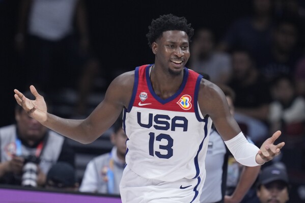 U.S. forward Jaren Jackson Jr. (13) questions the lack of a call against Jordan during the first half of a Basketball World Cup group C match in Manila, Philippines Wednesday, Aug. 30, 2023. (AP Photo/Michael Conroy)