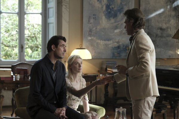 This image released by Sony Pictures Classics shows Mick Jagger, right, with Elizabeth Debicki and Claes Bang, left, in a scene from the film, "The Burnt Orange Heresy." Jagger plays a devilish art...