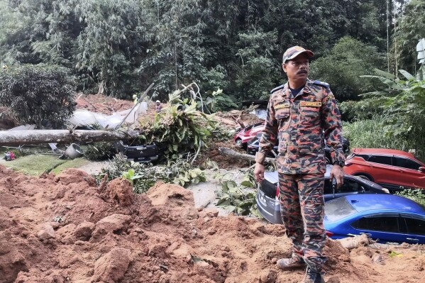 FILE - This photo released by Korporat JBPM, a rescue worker in an operation following a landslide at a campsite in Batang Kali, Selangor state, on the outskirts of Kuala Lumpur, Malaysia, Dec. 16, 2022. A landslide that killed 31 people at an unlicensed campground in 2022 was caused by persistent heavy rainfall, not human activity, a Malaysian government investigation concluded. (Korporat JBPM via AP, File)